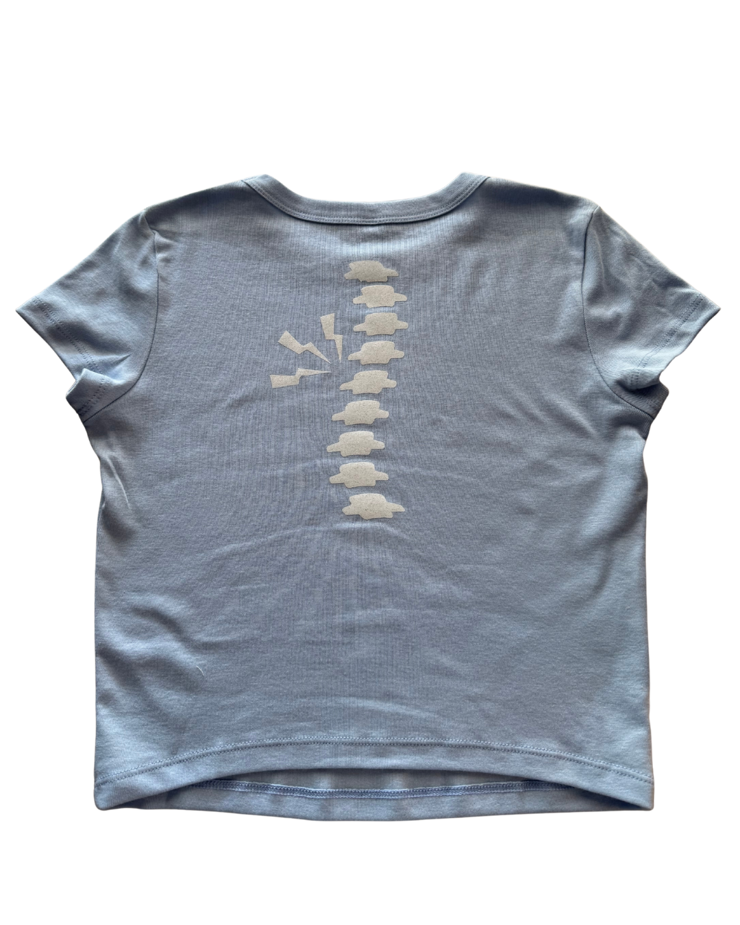 baby blue t-shirt with a white glitter spine design on the back against a white background
