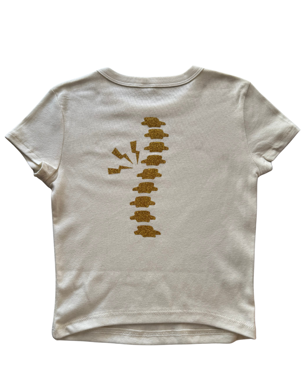 off-white t-shirt with gold glitter spine on a the back of the shirt on white background