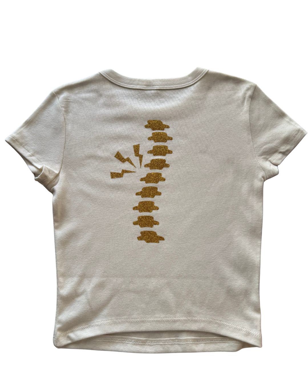 off-white t-shirt with gold glitter spine on a the back of the shirt on white background