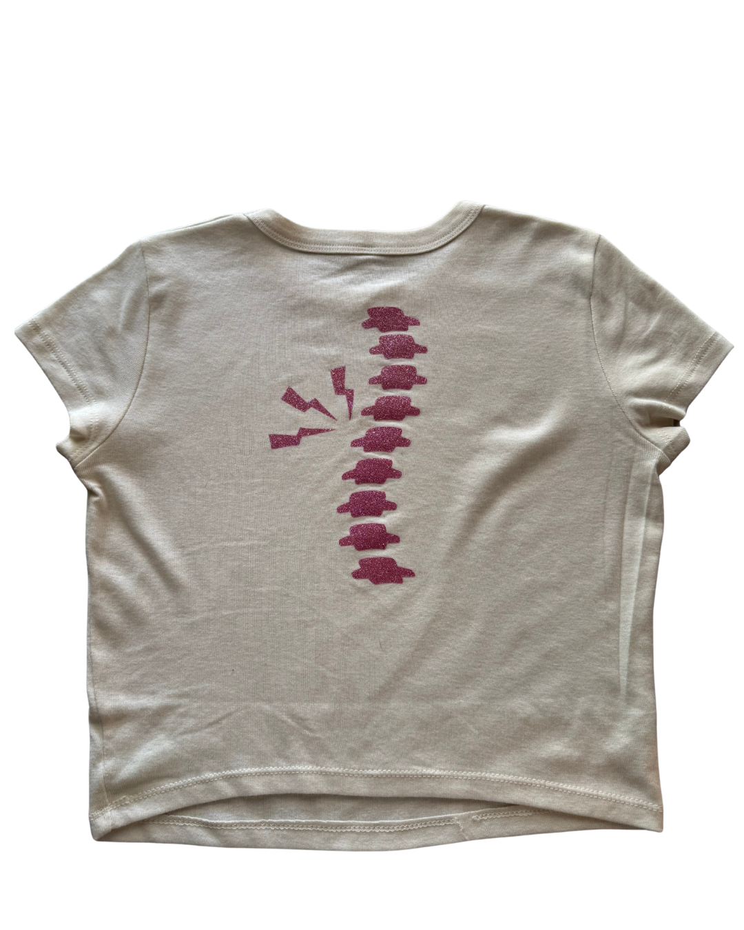 off-white t-shirt with a pink glitter spine on the back against a white background