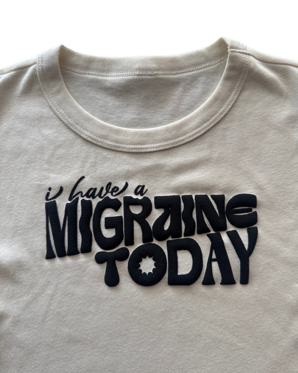 off-white t-shirt with 'I have a MIGRAINE TODAY' text in black on a white background