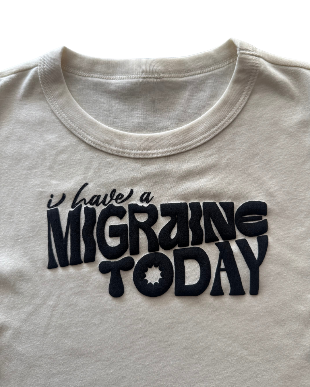 off-white t-shirt with 'I have a MIGRAINE TODAY' text in black on a white background