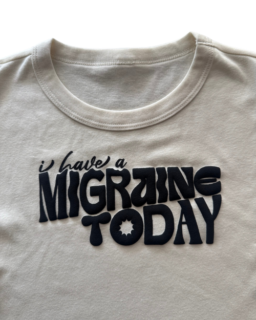 off-white t-shirt with 'I have a MIGRAINE TODAY' text in black on a white background