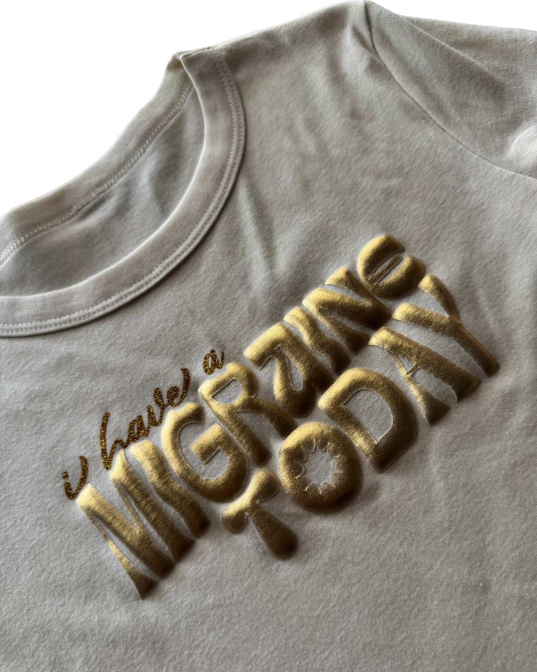 off-white t-shirt with gold text on a white background