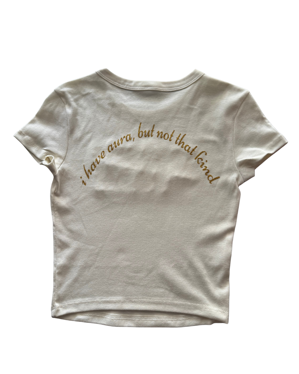 White t-shirt with gold text "i have aura, but not that kind" on a white background