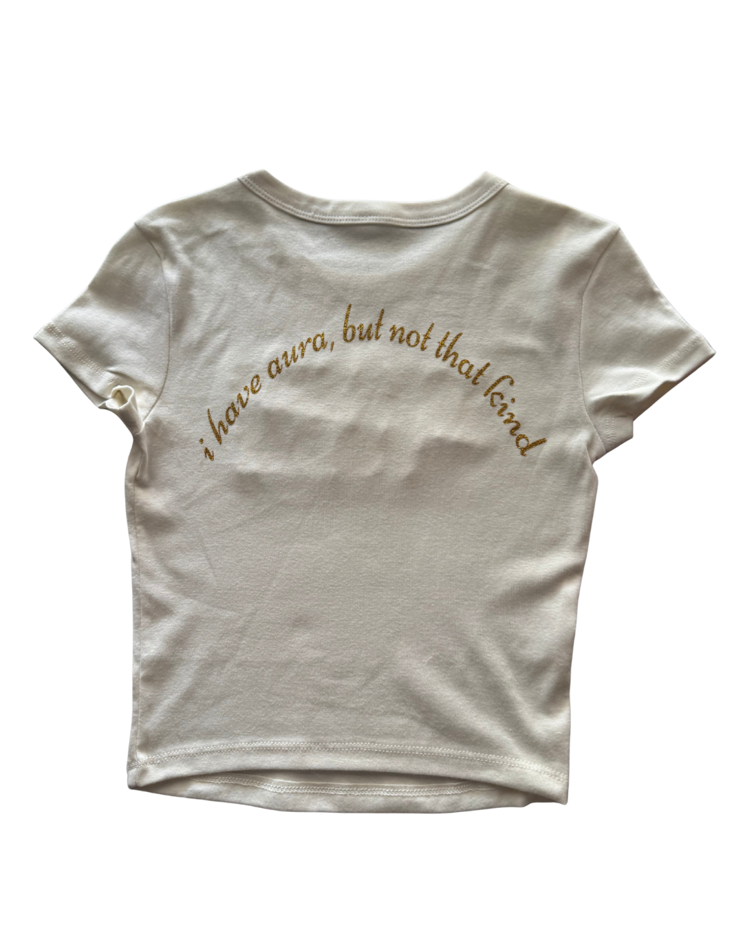 White t-shirt with gold text "i have aura, but not that kind" on a white background