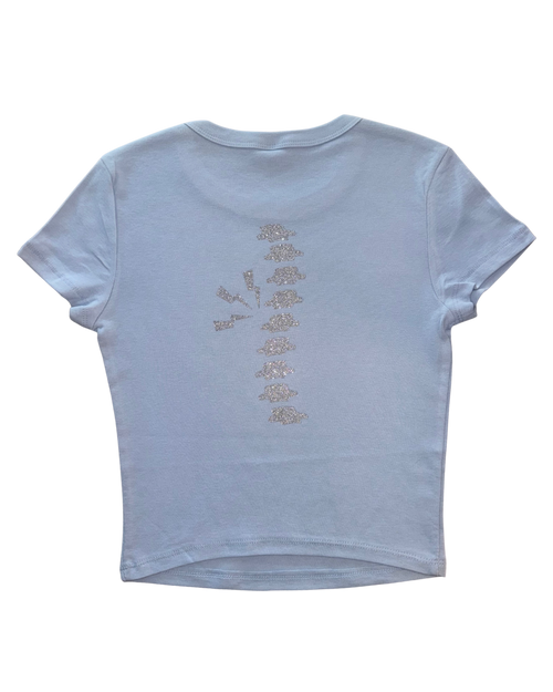 Light blue t-shirt with a silver glitter spine on a white background