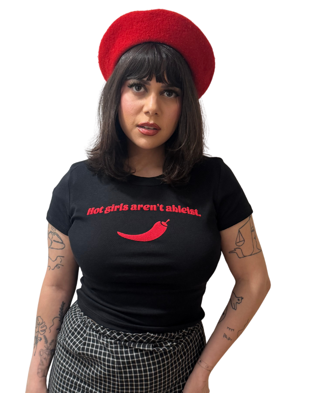 Person wearing a black t-shirt with red text and a red beret on a white background