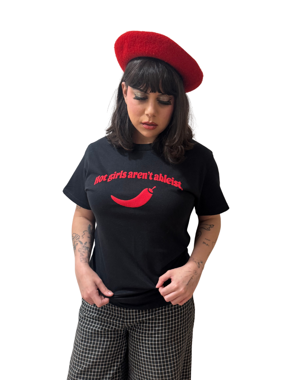 Person wearing a black t-shirt with red text and a red beret on a white background