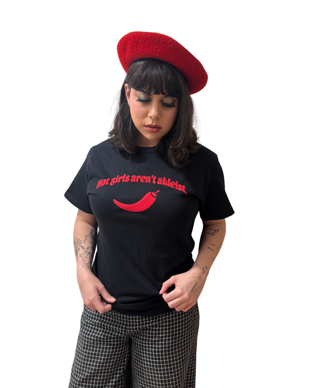 Person wearing a black t-shirt with red text and a red beret on a white background