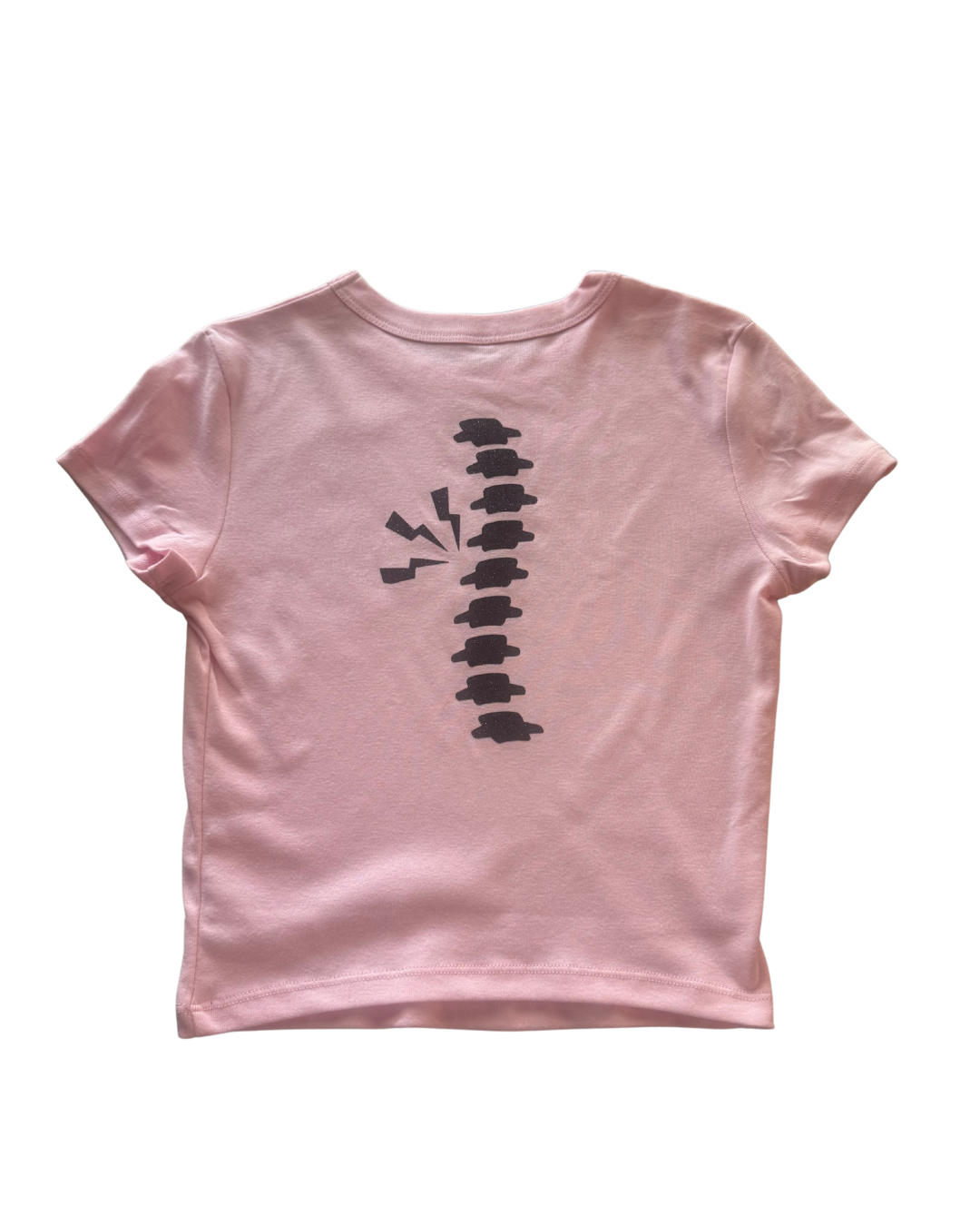 Pink t-shirt with black spine in glitter design on a white background
