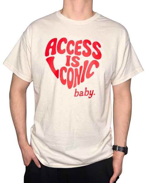 A close-up photo of a man wearing a regular length cotton t-shirt with the "Access Is Iconic Baby" design in red. It's in the center of the tshirt. 