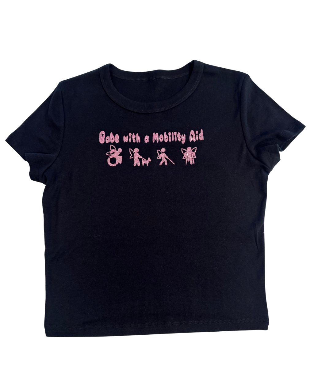 Black t-shirt with pink glitter text that says "Babe with a mobility aid" in bubble letter typography and disability symbols on a white background