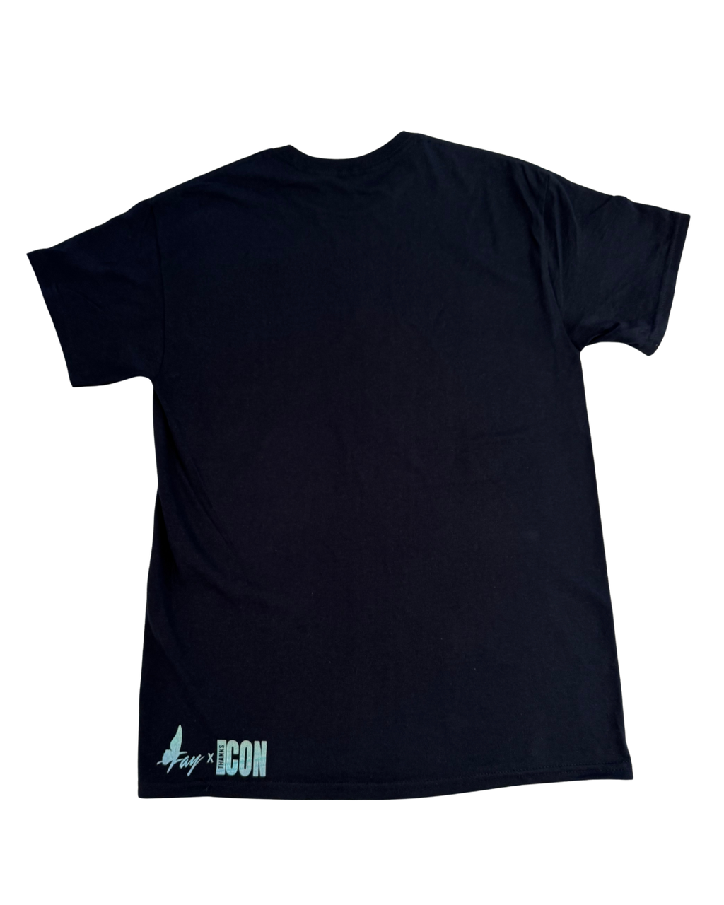 Back of black t-shirt with text on the back against a white background. The bottom left corner has the Fay x Thanks Icon logos.