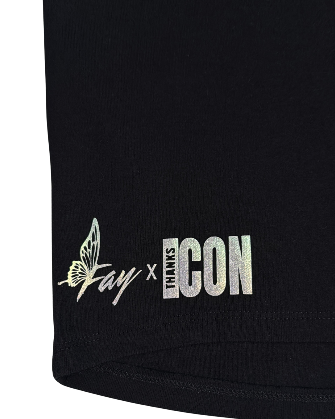 Close up of back part of black t-shirt with the Fay x Thank Icon logos in pearlescent vinyl against a white background