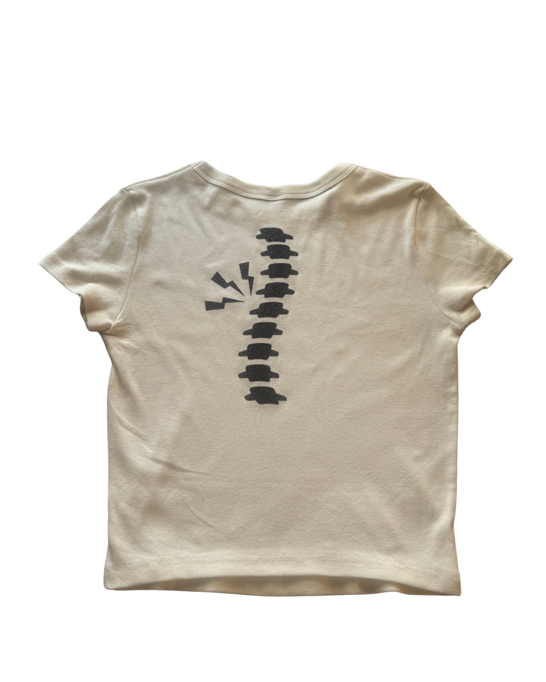 off-white t-shirt with black glitter spine graphic design on the back against a white background