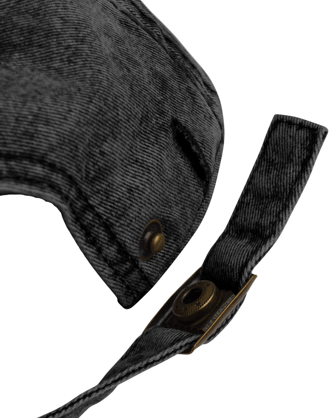 Close-up of a black denim cap with a strap on a white background