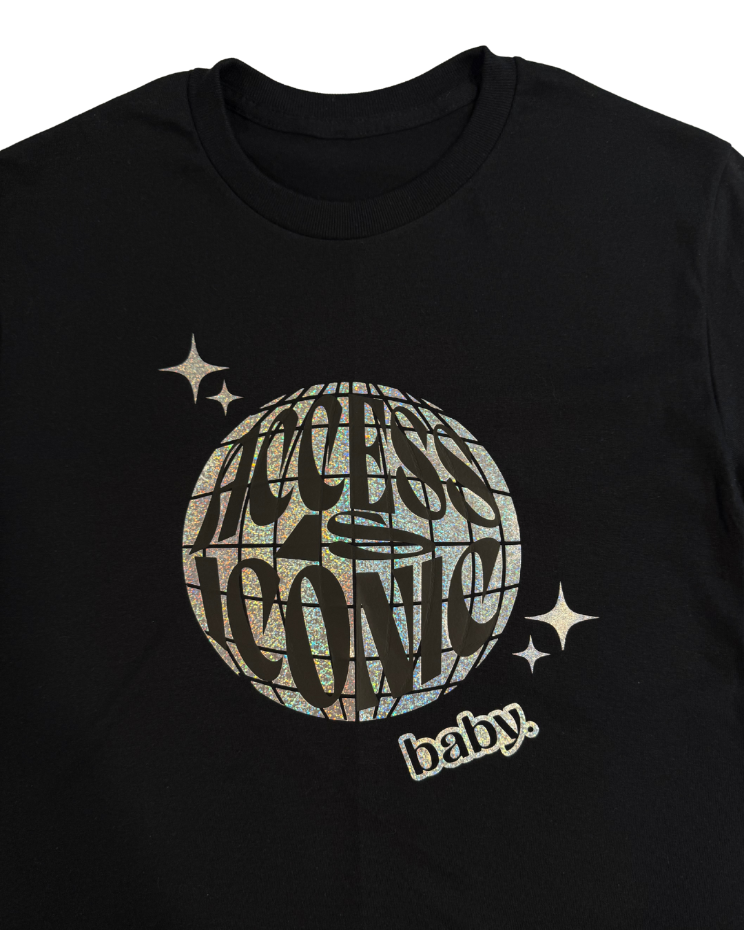 close up of tshirt with holographic "access is iconic baby" disco ball graphic design on it