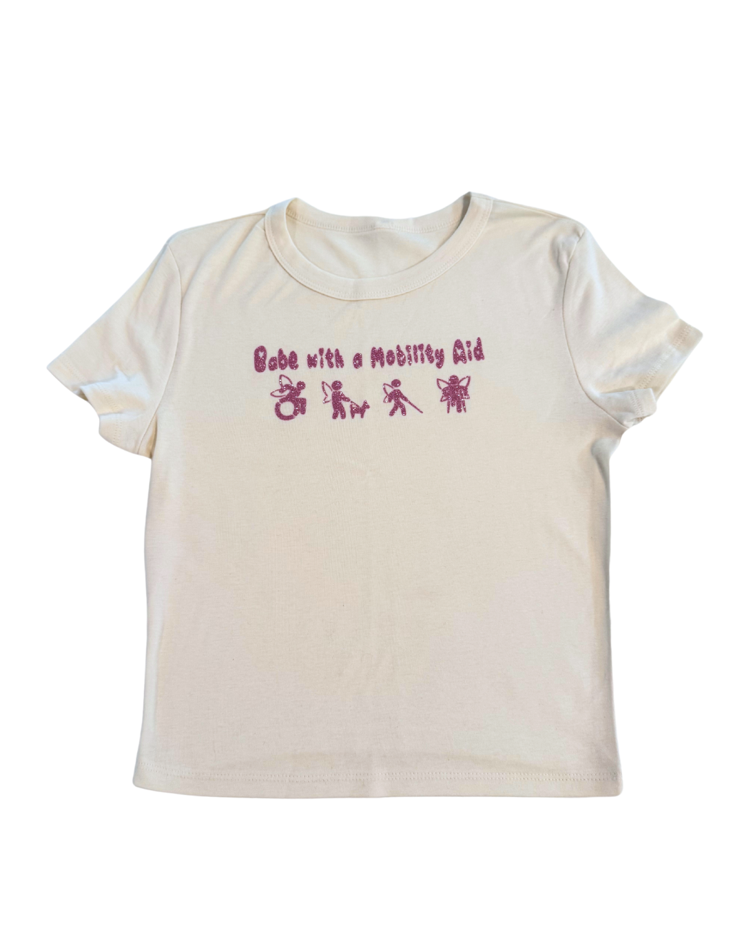off-white t-shirt with pink glitter text that says "Babe with a mobility aid" in bubble letter typography and disability symbols on a white background