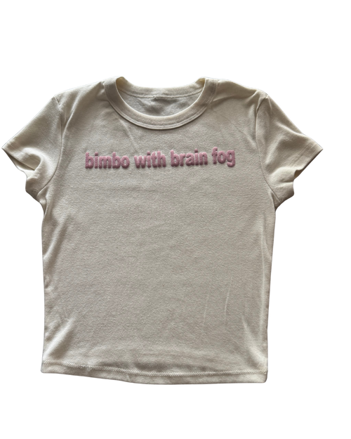 White t-shirt with pink text 'bimbo with brain fog' on a white background